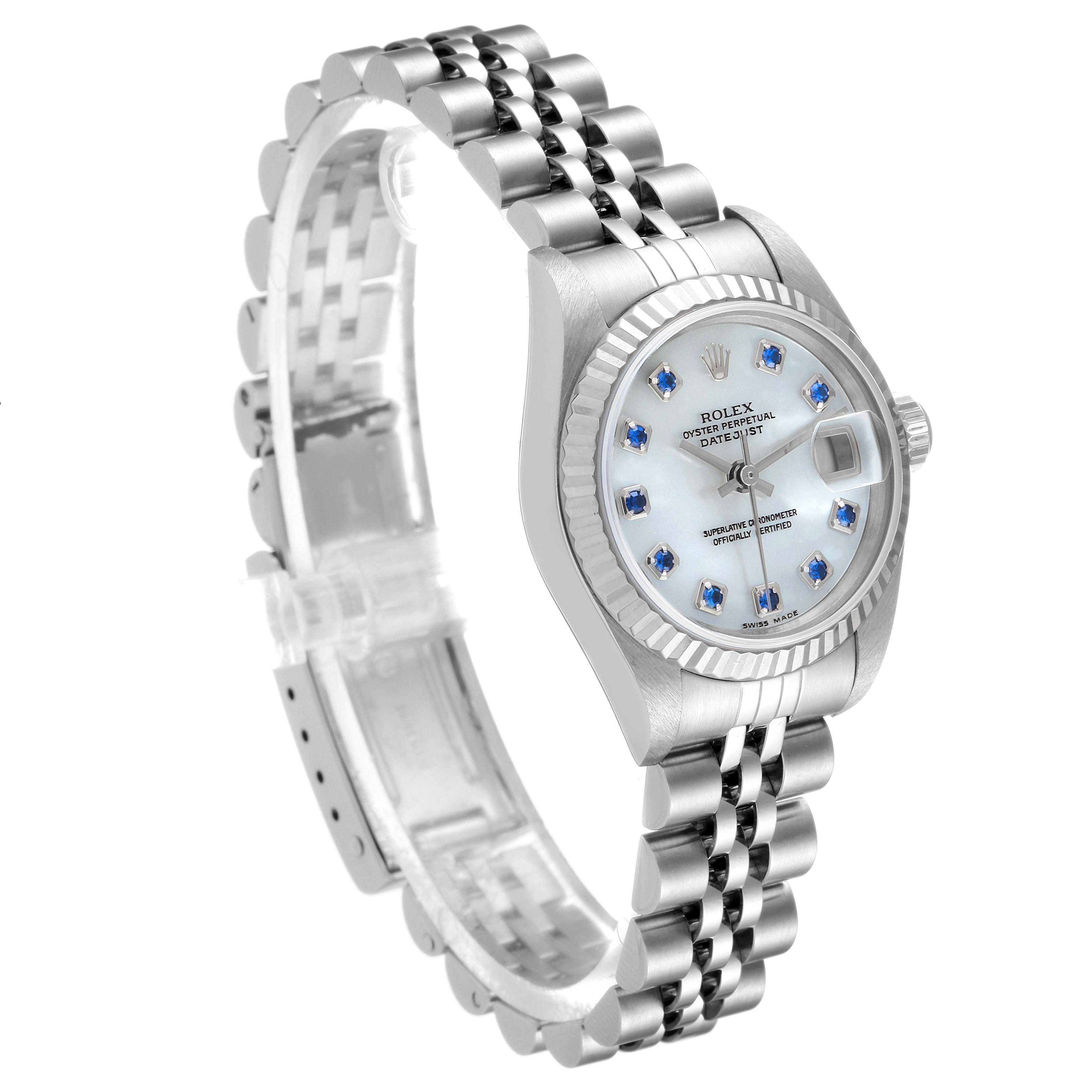 This Rolex Datejust 79174 Women
s Stainless Steel Mother of Pearl Dial 79174 Women
s Stainless Steel Mother of Pearl Dial watch is shown at an angled view, displaying its face, fluted bezel, and Jubilee bracelet.