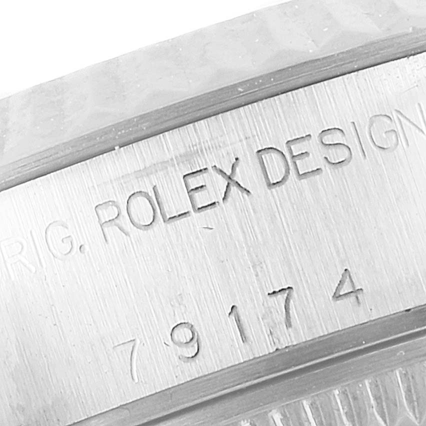 This is a close-up of the side of a Rolex Datejust 79174 Women
s Stainless Steel Mother of Pearl Dial 79174 Women
s Stainless Steel Mother of Pearl Dial watch, showing the engraved text and serial number.
