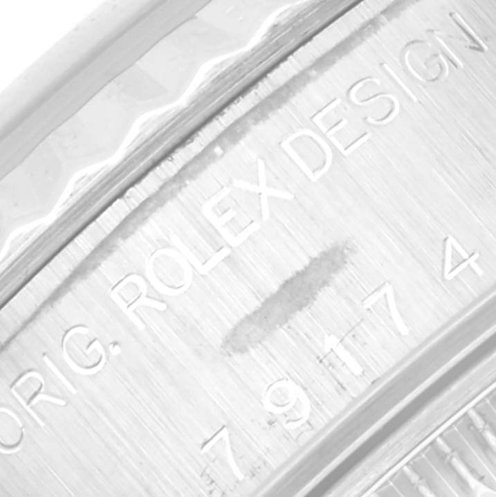 This is a close-up shot of the engraved bezel on a Rolex Datejust 79174 Women's Stainless Steel Mother of Pearl Dial 79174 Women's Stainless Steel Mother of Pearl Dial watch.