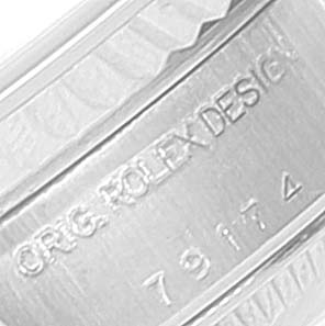 This close-up image shows the inner side of the caseback of a Rolex Datejust 79174 Women's Stainless Steel White Dial 79174 Women's Stainless Steel White Dial model, highlighting the engraved text.