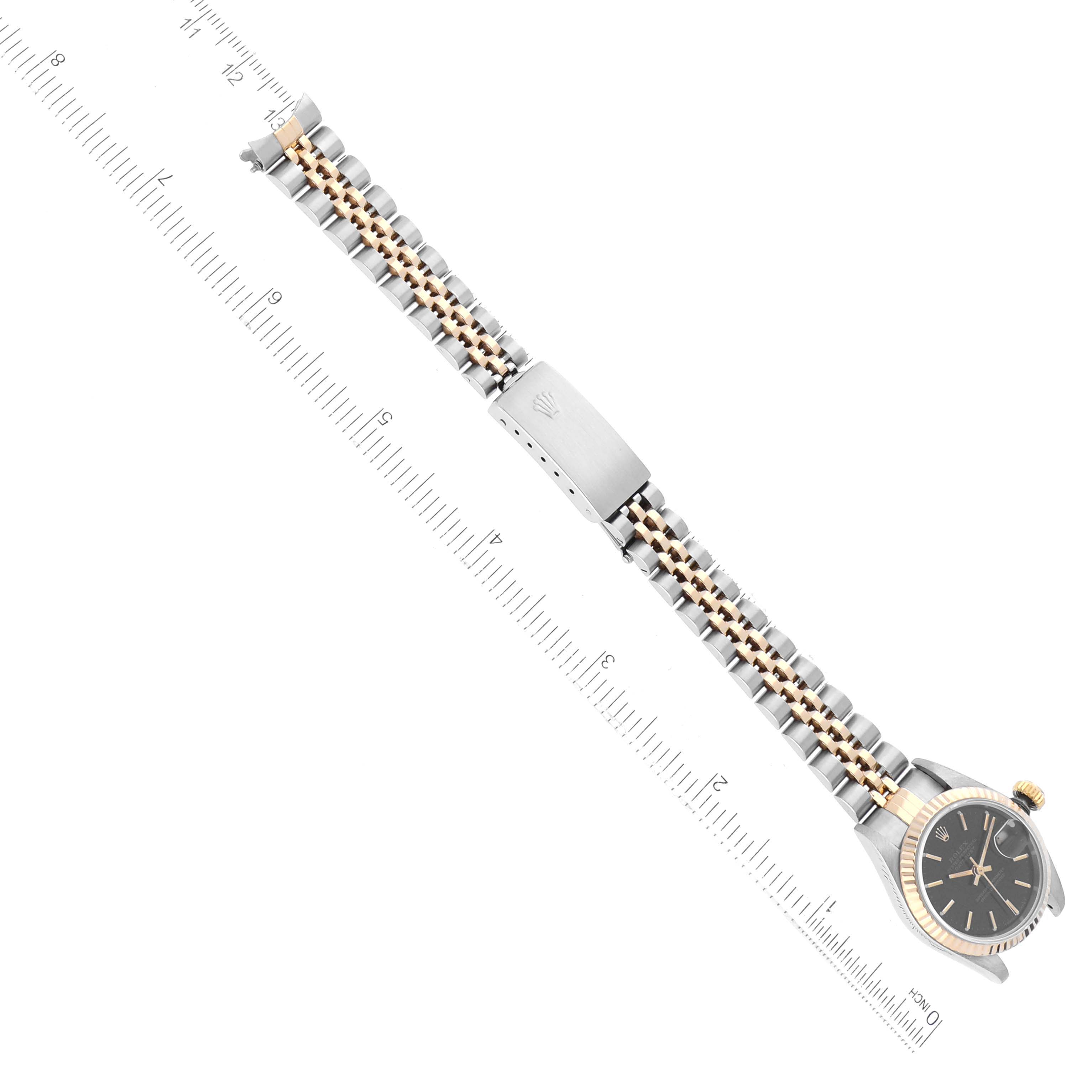 The image shows a Rolex Datejust 69173 Women's Steel and Gold (two tone) Black Dial 69173 Women's Steel and Gold (two tone) Black Dial watch, including its bracelet laid flat next to a ruler for measurement.