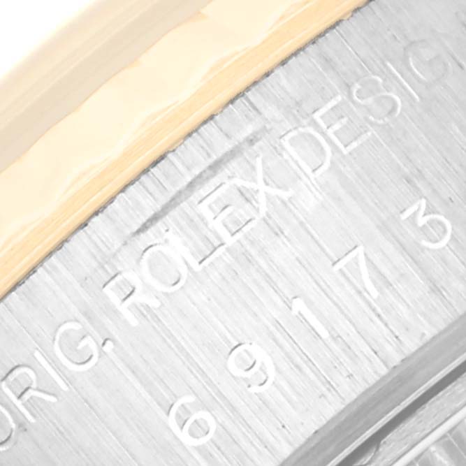 The image shows the engraved edge of a Rolex Datejust 69173 Women's Steel and Gold (two tone) Black Dial 69173 Women's Steel and Gold (two tone) Black Dial model, highlighting the brand name and design details.