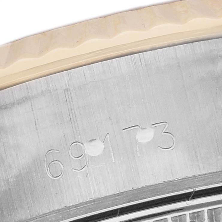 This image shows a close-up view of the serial number engraving on the casing of a Rolex Datejust 69173 Women's Steel and Gold (two tone) Black Dial 69173 Women's Steel and Gold (two tone) Black Dial watch.