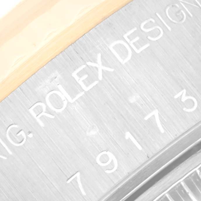 This image shows a close-up of the side engraving on the case of a Rolex Datejust 79173 Women's Steel and Gold (two tone) Champagne Dial 79173 Women's Steel and Gold (two tone) Champagne Dial watch.