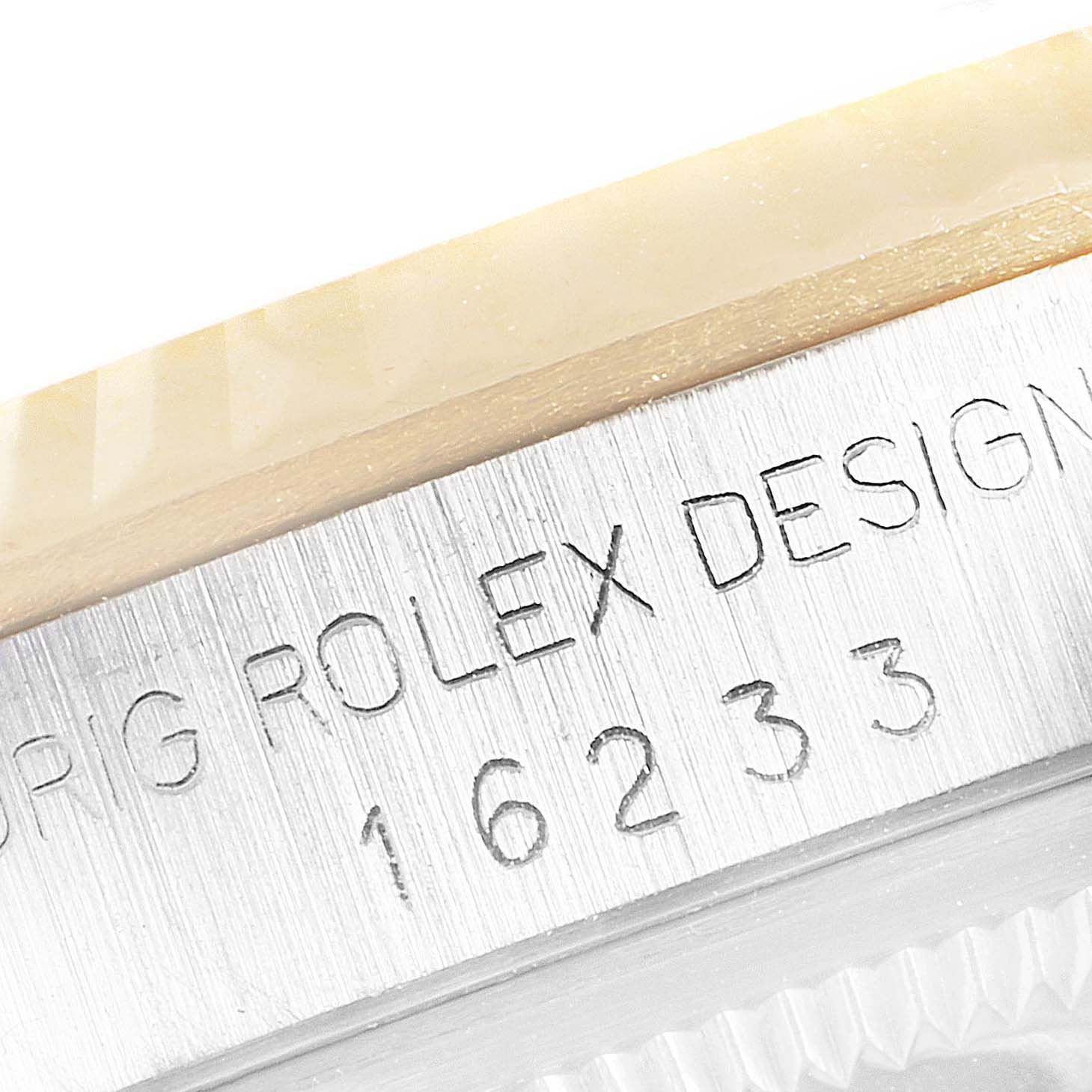This close-up image focuses on the engraved case side of the Rolex Datejust 16233 Men's Steel and Gold (two tone) Champagne Dial 16233 Men's Steel and Gold (two tone) Champagne Dial model.