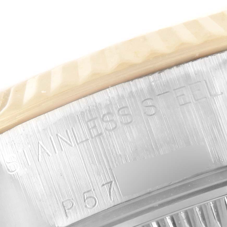 This is a close-up angle of the bezel and case back edge of a Rolex Datejust 79173 Women
s Steel and Gold (two tone) Silver Dial 79173 Women
s Steel and Gold (two tone) Silver Dial watch, showing the "Stainless Steel" engraving.
