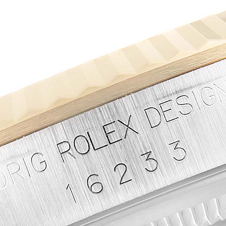 This is a close-up of the side engraving and bezel of a Rolex Datejust 16233 Men's Steel and Gold (two tone) Champagne Dial 16233 Men's Steel and Gold (two tone) Champagne Dial model, showing the model number 16233.