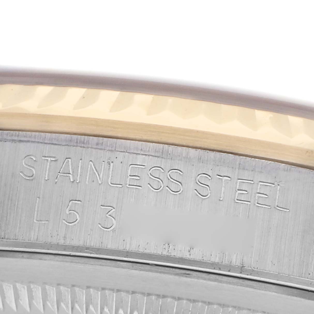 The image shows a close-up of the engraved stainless steel part of a Rolex Datejust 16233 Men's Steel and Gold (two tone) Silver Dial 16233 Men's Steel and Gold (two tone) Silver Dial watch.