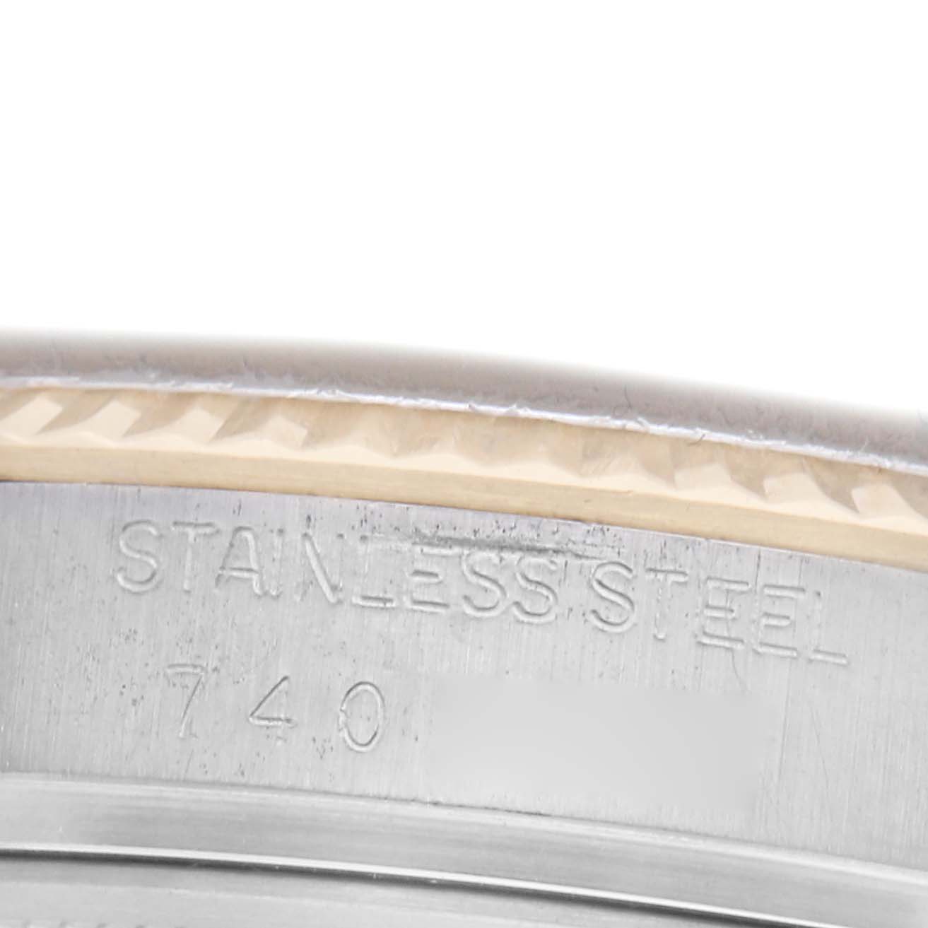 The image shows a close-up of the Rolex Datejust 16013 Men's Steel and Gold (two tone) White Dial 16013 Men's Steel and Gold (two tone) White Dial watch case rim, focusing on the "STAINLESS STEEL" engraving.