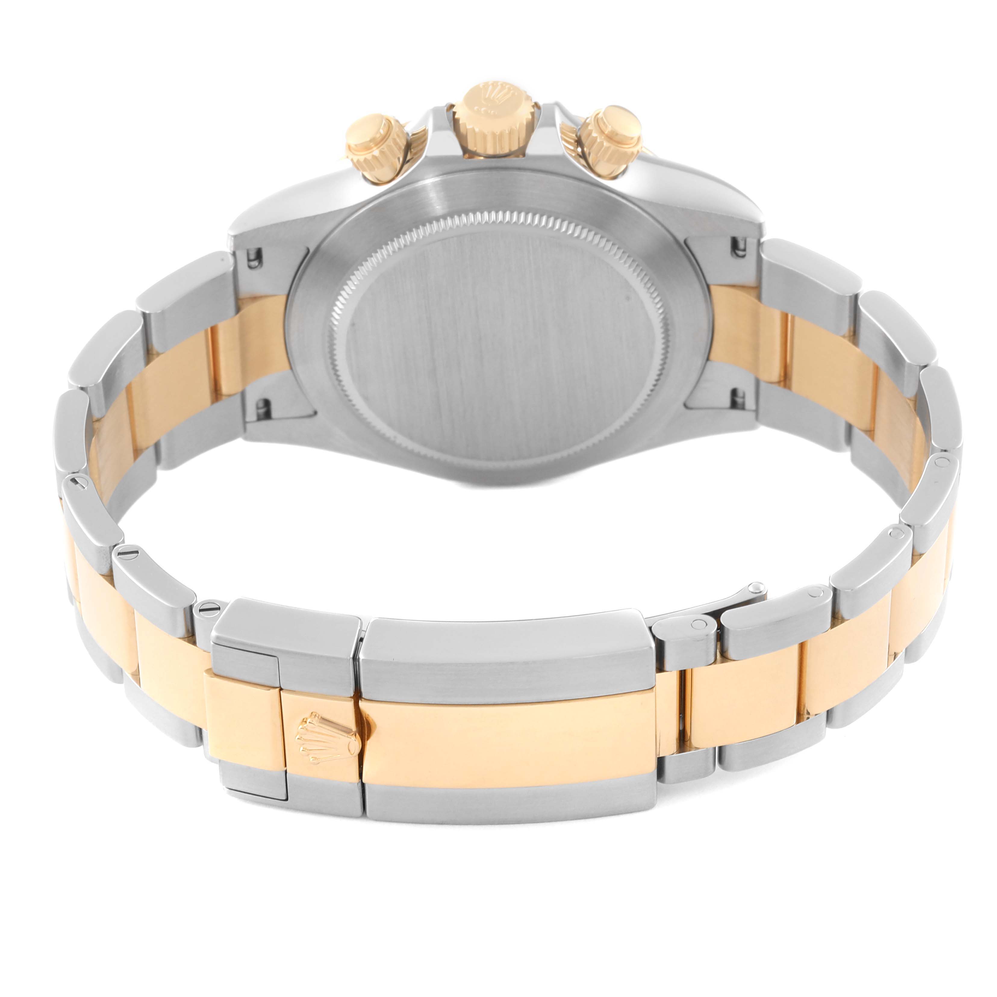 This image shows the back view of a Rolex Daytona 116503 Men's Steel and Gold (two tone) Black Dial 116503 Men's Steel and Gold (two tone) Black Dial watch, highlighting its bracelet and clasp in two-tone metal.