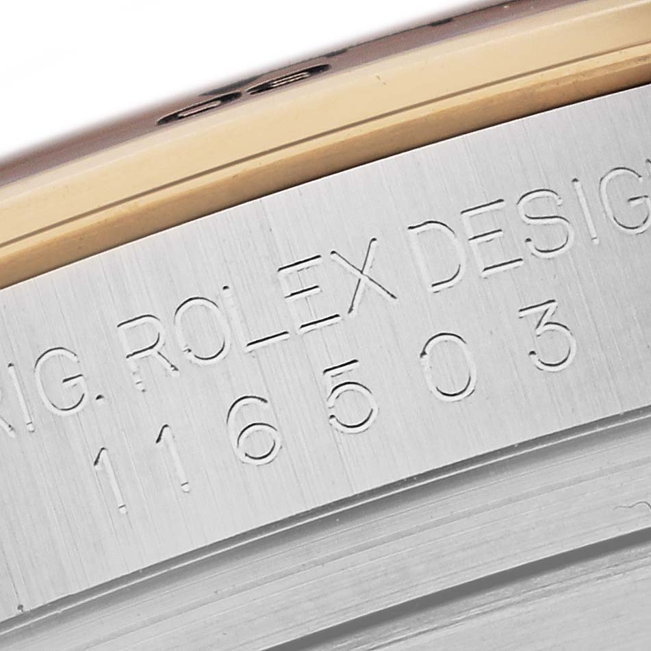 This close-up image showcases the engraved model and design number on the side of a Rolex Daytona 116503 Men's Steel and Gold (two tone) Mother of Pearl Dial 116503 Men's Steel and Gold (two tone) Mother of Pearl Dial watch's case.