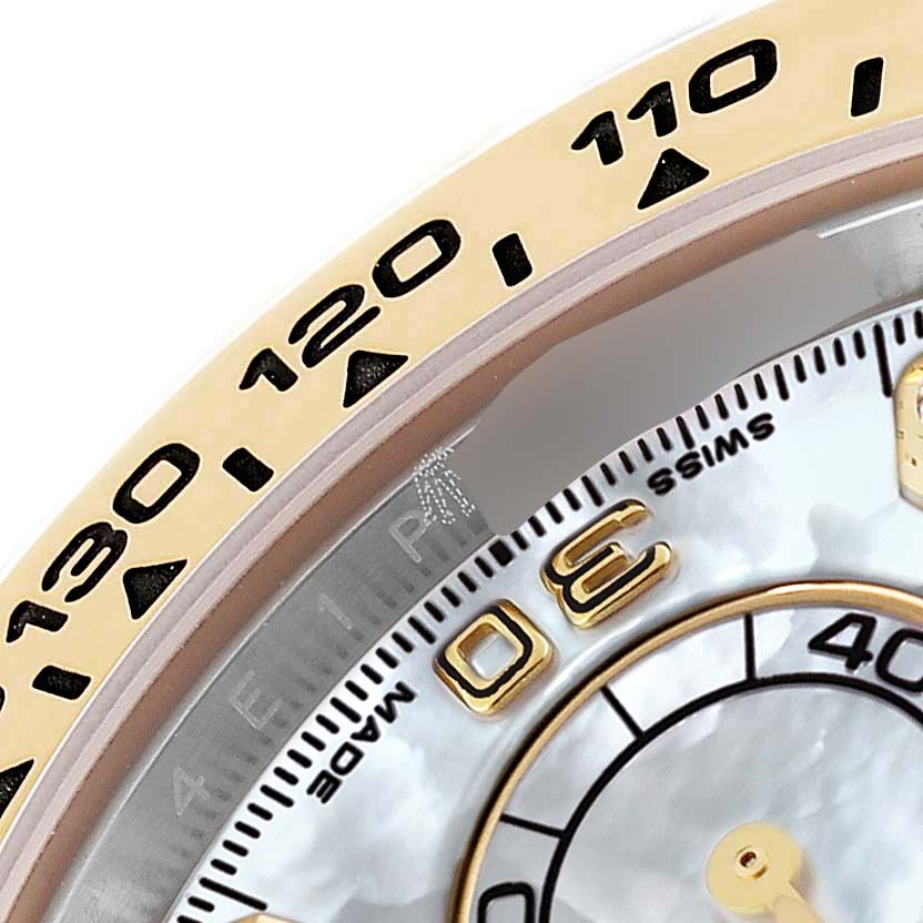 This image shows a close-up of the bezel and part of the dial of a Rolex Daytona 116503 Men's Steel and Gold (two tone) Mother of Pearl Dial 116503 Men's Steel and Gold (two tone) Mother of Pearl Dial watch.