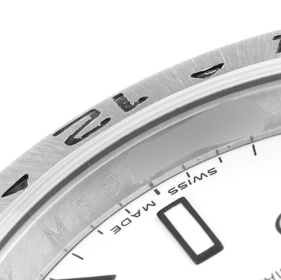 This is a close-up of the bezel and part of the dial of a Rolex Explorer 16570 Men
s Stainless Steel White Dial 16570 Men
s Stainless Steel White Dial watch.