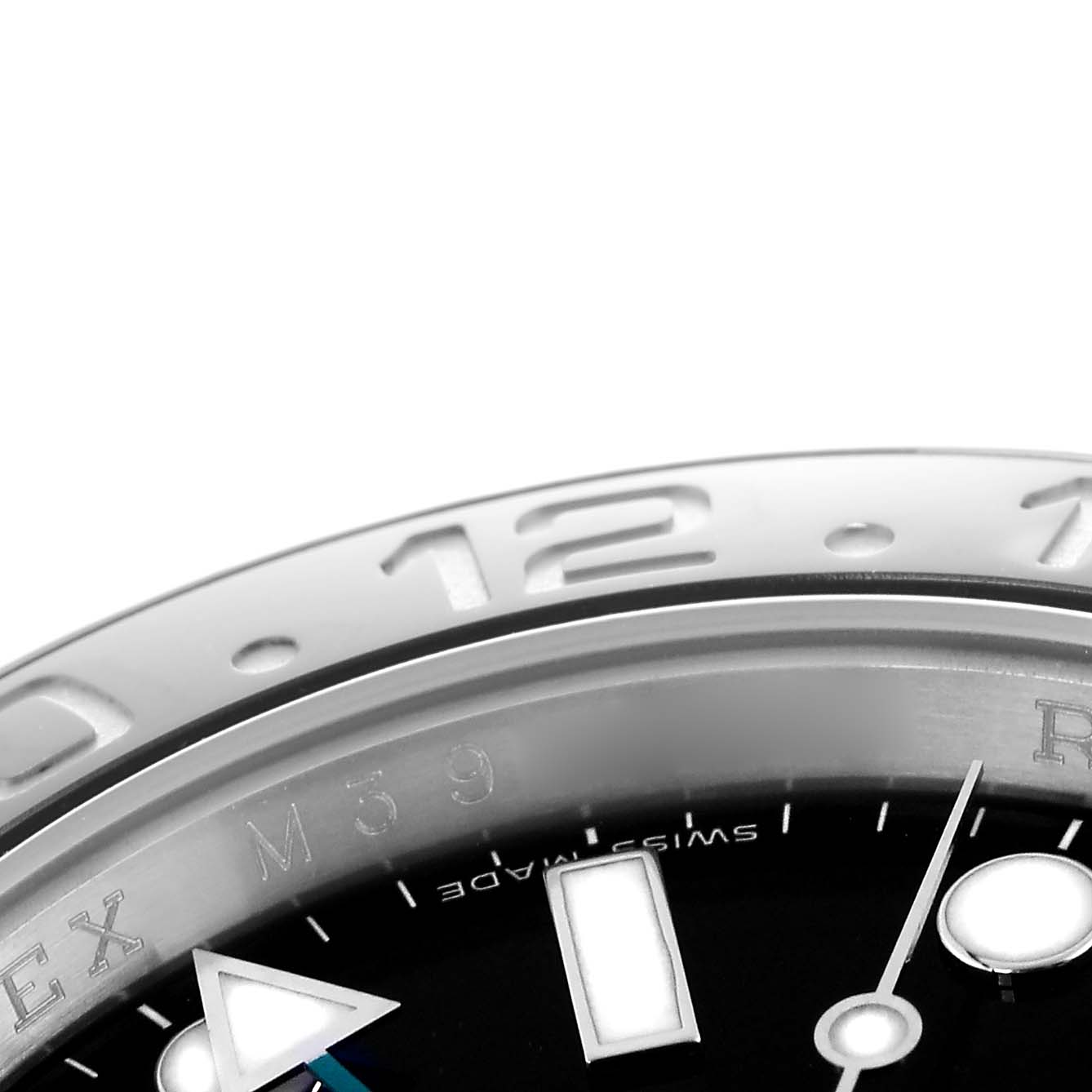 The image shows a close-up of the Rolex GMT-Master 116710 Men's Stainless Steel Black Dial 116710 Men's Stainless Steel Black Dial's bezel and part of the dial, highlighting the 12 o'clock marker and hands.