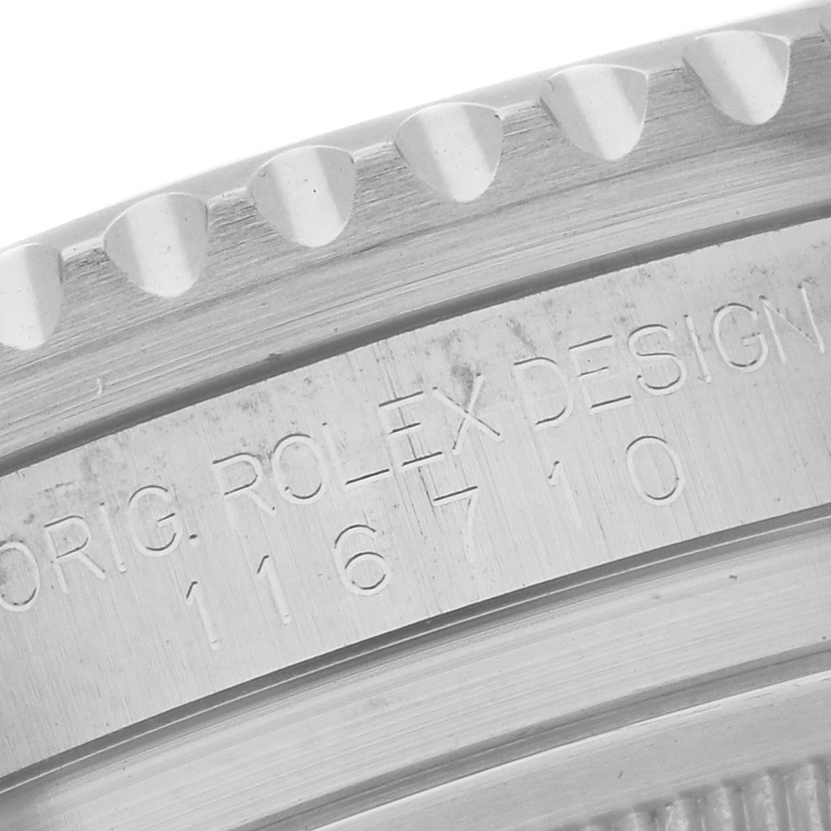 This close-up image of a Rolex GMT-Master 116710 Men's Stainless Steel Black Dial 116710 Men's Stainless Steel Black Dial watch shows the engraved model number and part of the bezel.