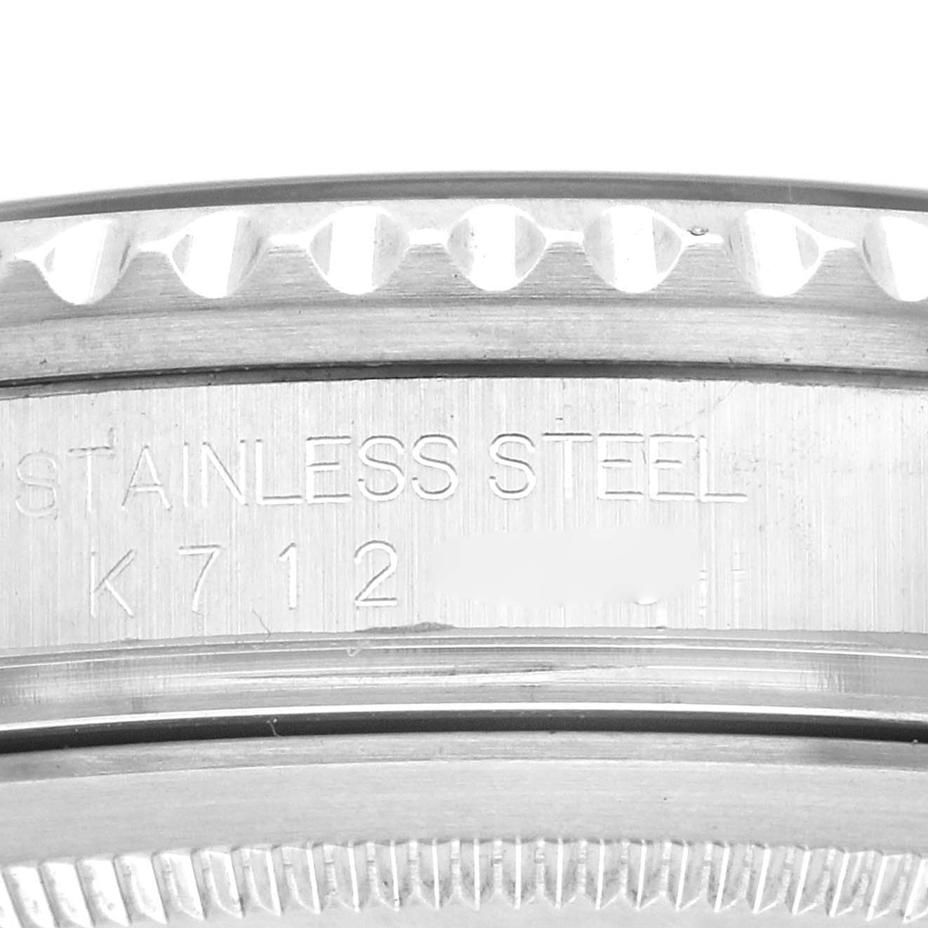 The image shows a close-up of the edge and engraving on the stainless steel case of a Rolex GMT-Master 16710 Men's Stainless Steel Black Dial 16710 Men's Stainless Steel Black Dial watch.