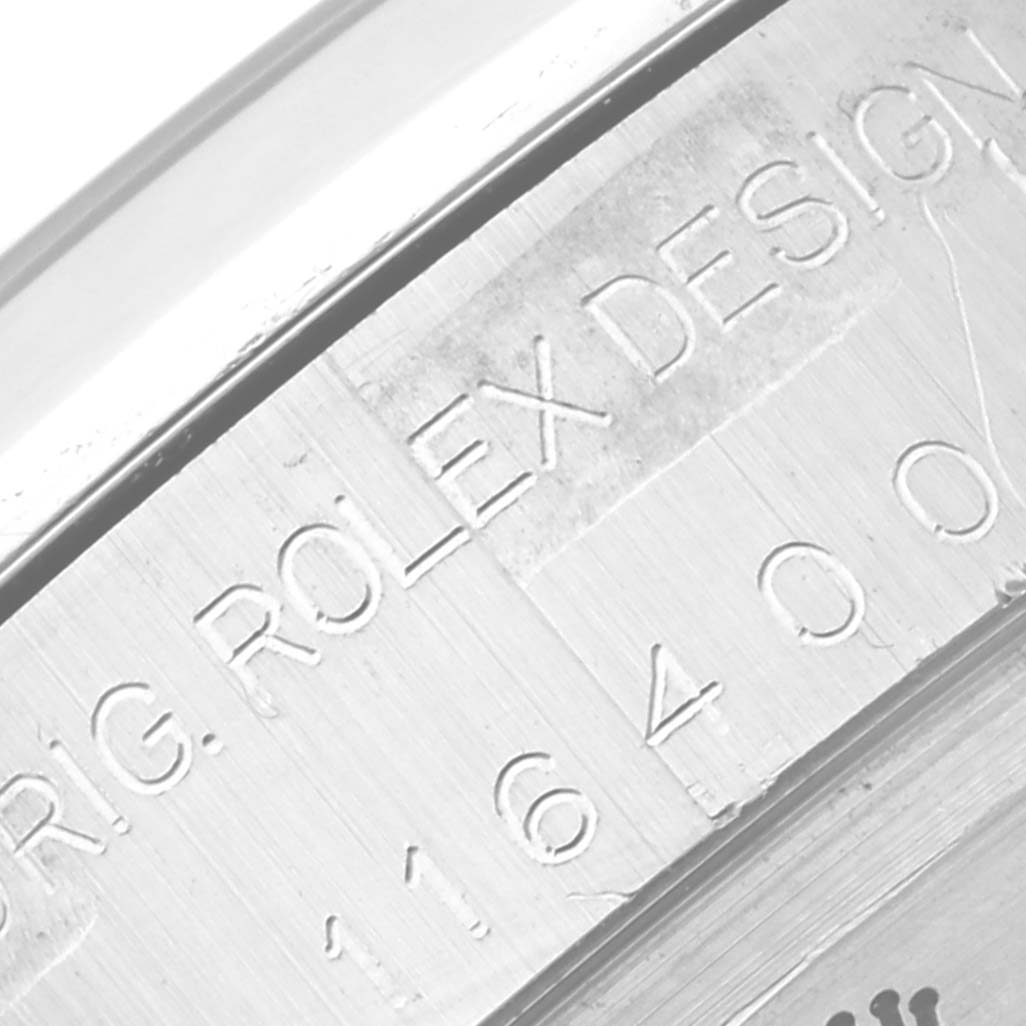 Close-up of the engraved casing of a Rolex Milgauss 116400 Men's Stainless Steel White Dial 116400 Men's Stainless Steel White Dial watch featuring "ROLEX DESIGN" and model number.
