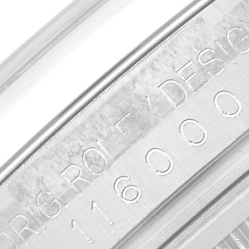 This close-up image shows the engraved serial number and "Rolex" branding on the bezel of a Rolex Oyster Perpetual 116000 Men
s Stainless Steel Black Dial 116000 Men
s Stainless Steel Black Dial watch.
