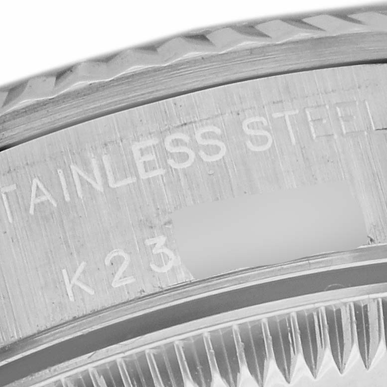This image shows a close-up of the bezel and serial number of a Rolex Oyster Perpetual 76094 Women's Stainless Steel Pink Dial 76094 Women's Stainless Steel Pink Dial watch, highlighting the stainless steel material.