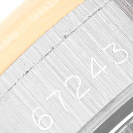 The image shows a close-up of the serial number on the side of a Rolex Oyster Perpetual 67243 Women's Steel and Gold (two tone) Champagne Dial 67243 Women's Steel and Gold (two tone) Champagne Dial model watch.