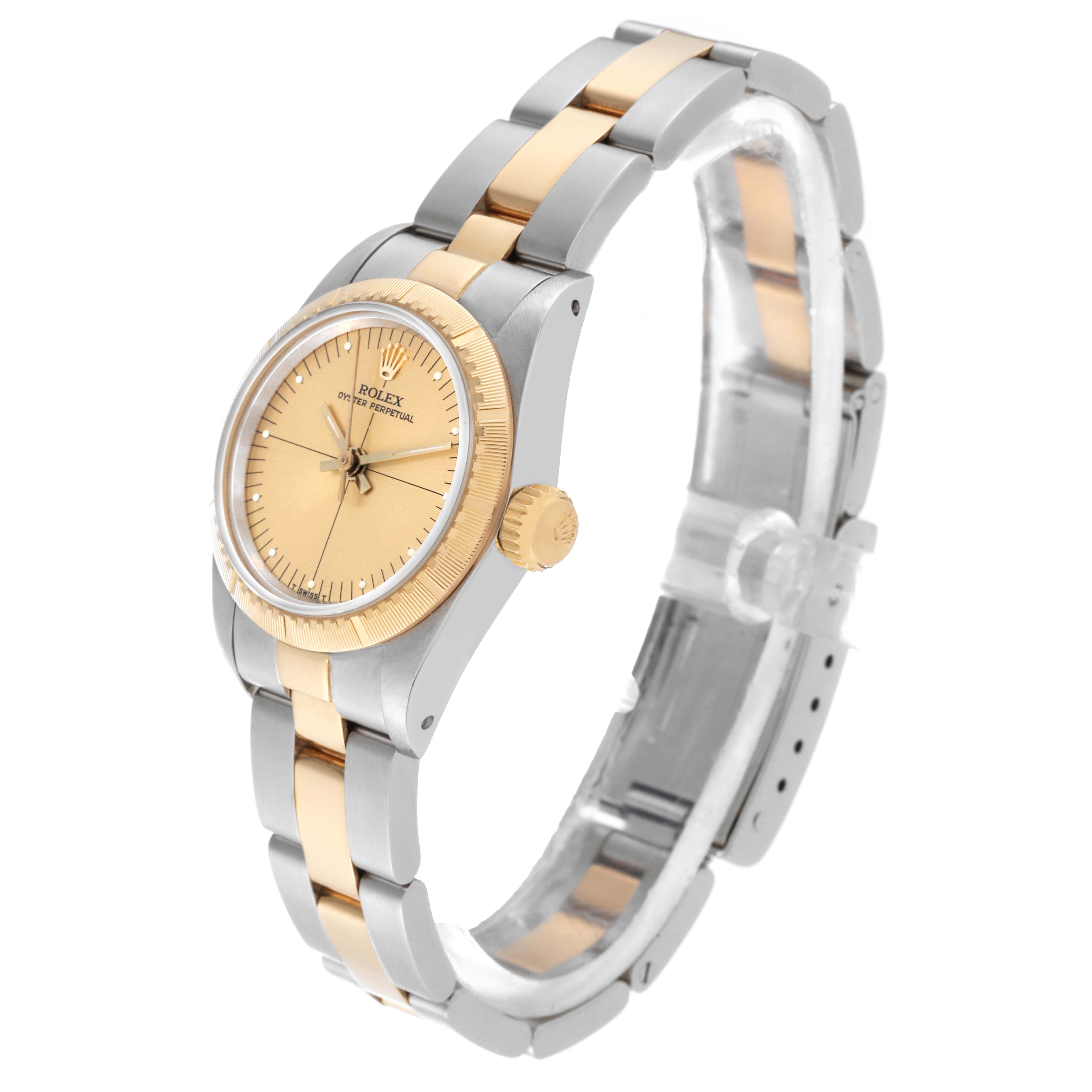 The Rolex Oyster Perpetual 67243 Women's Steel and Gold (two tone) Champagne Dial 67243 Women's Steel and Gold (two tone) Champagne Dial watch is viewed at an angle showcasing the dial, bezel, crown, and two-tone bracelet.