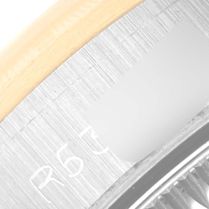 This close-up of the Rolex Oyster Perpetual 67243 Women's Steel and Gold (two tone) Champagne Dial 67243 Women's Steel and Gold (two tone) Champagne Dial watch shows part of the bezel and the edge of the dial.