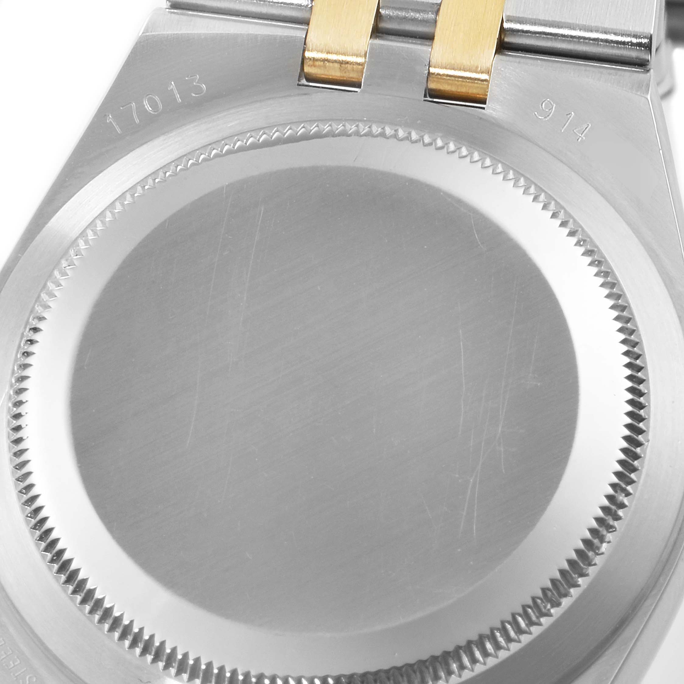 This image shows the case back of a Rolex Oysterquartz 17013 Men's Steel and Gold (two tone) Champagne Dial 17013 Men's Steel and Gold (two tone) Champagne Dial watch, featuring its brushed metal finish.