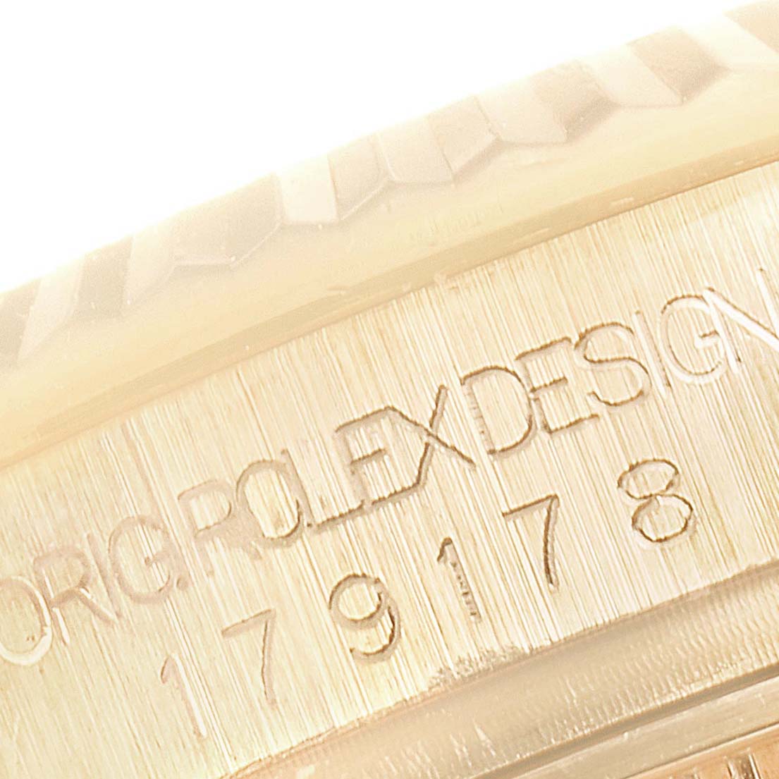This image shows a close-up of the engraved text on the casing of a Rolex President 179178 Women
s Yellow Gold Champagne Dial 179178 Women
s Yellow Gold Champagne Dial model watch.