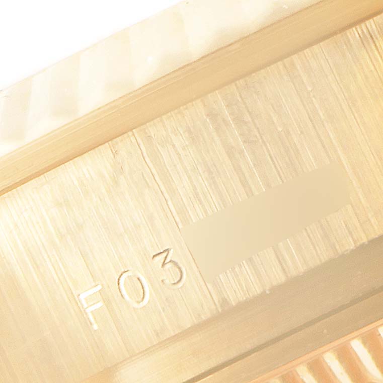 This close-up image of a Rolex President 179178 Women
s Yellow Gold Champagne Dial 179178 Women
s Yellow Gold Champagne Dial watch shows part of the bracelet and the stamped serial number inside the clasp.