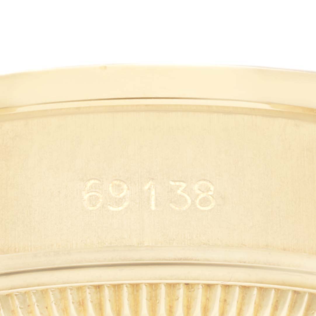 This image shows a close-up of the case back engraving on a Rolex President 69138 Women
s Yellow Gold Champagne Dial 69138 Women
s Yellow Gold Champagne Dial model watch, displaying the model number "69138."