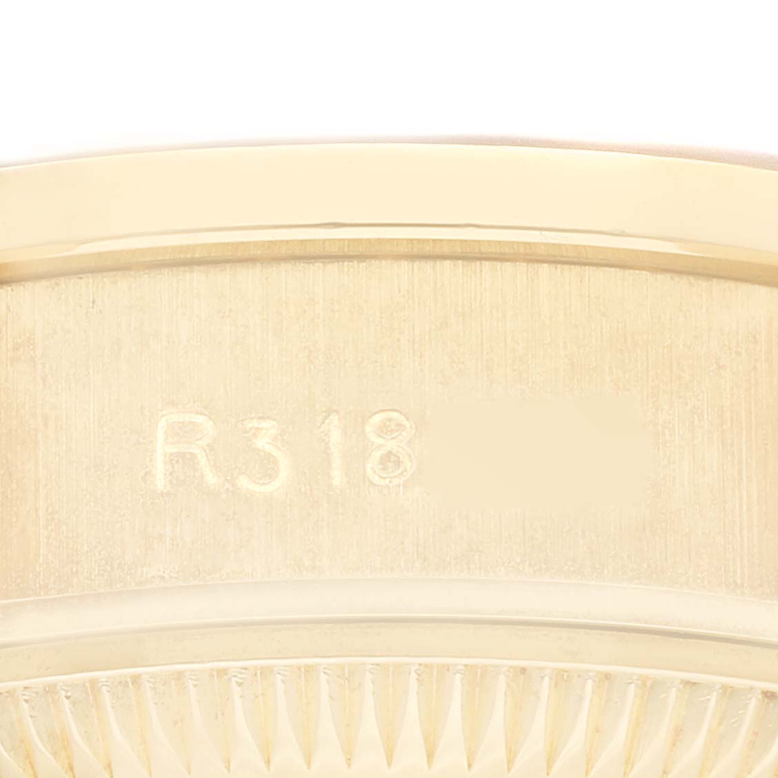 The close-up image shows the side view of a Rolex President 69138 Women
s Yellow Gold Champagne Dial 69138 Women
s Yellow Gold Champagne Dial model watch, focusing on part of the serial number and edge detailing.