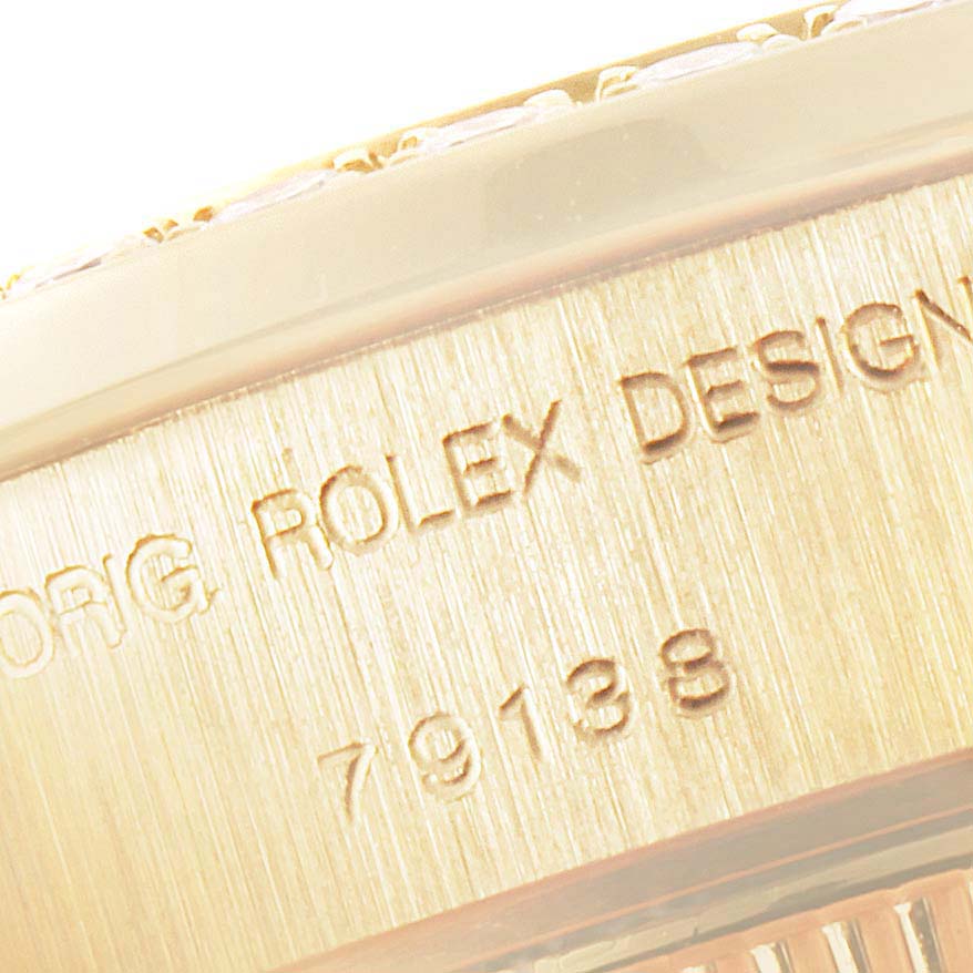 The image shows a close-up of the side of a Rolex President 79138 Women
s Yellow Gold Champagne Dial 79138 Women
s Yellow Gold Champagne Dial model watch, highlighting the engraving.