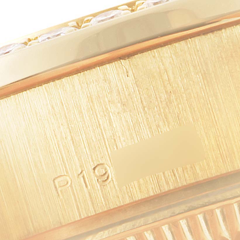 This image shows a close-up of the side of a Rolex President 79138 Women
s Yellow Gold Champagne Dial 79138 Women
s Yellow Gold Champagne Dial watch, highlighting its gold texture and engraving.