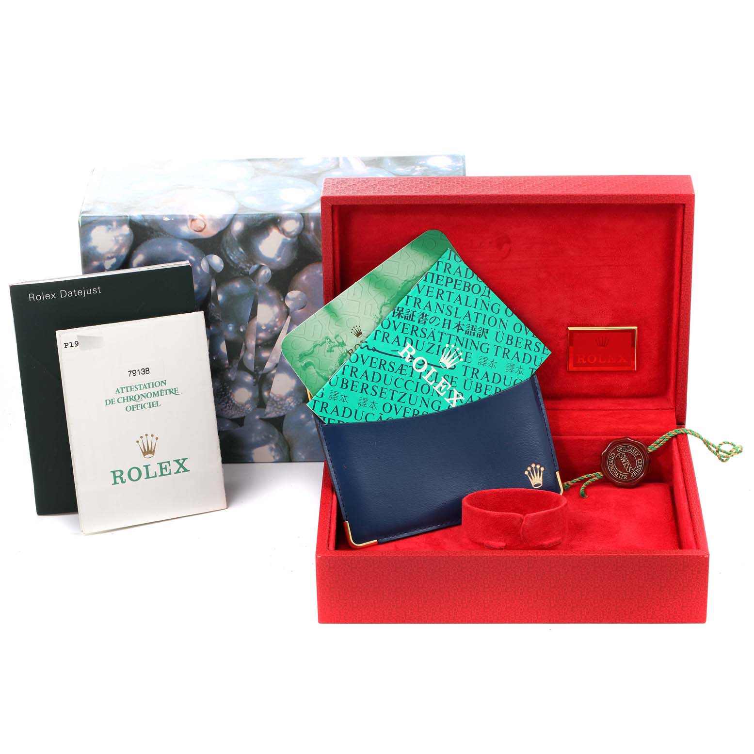 This image shows the packaging and accessories for a Rolex President 79138 Women
s Yellow Gold Champagne Dial 79138 Women
s Yellow Gold Champagne Dial model watch at a front angle, including a box, booklet, and tags.