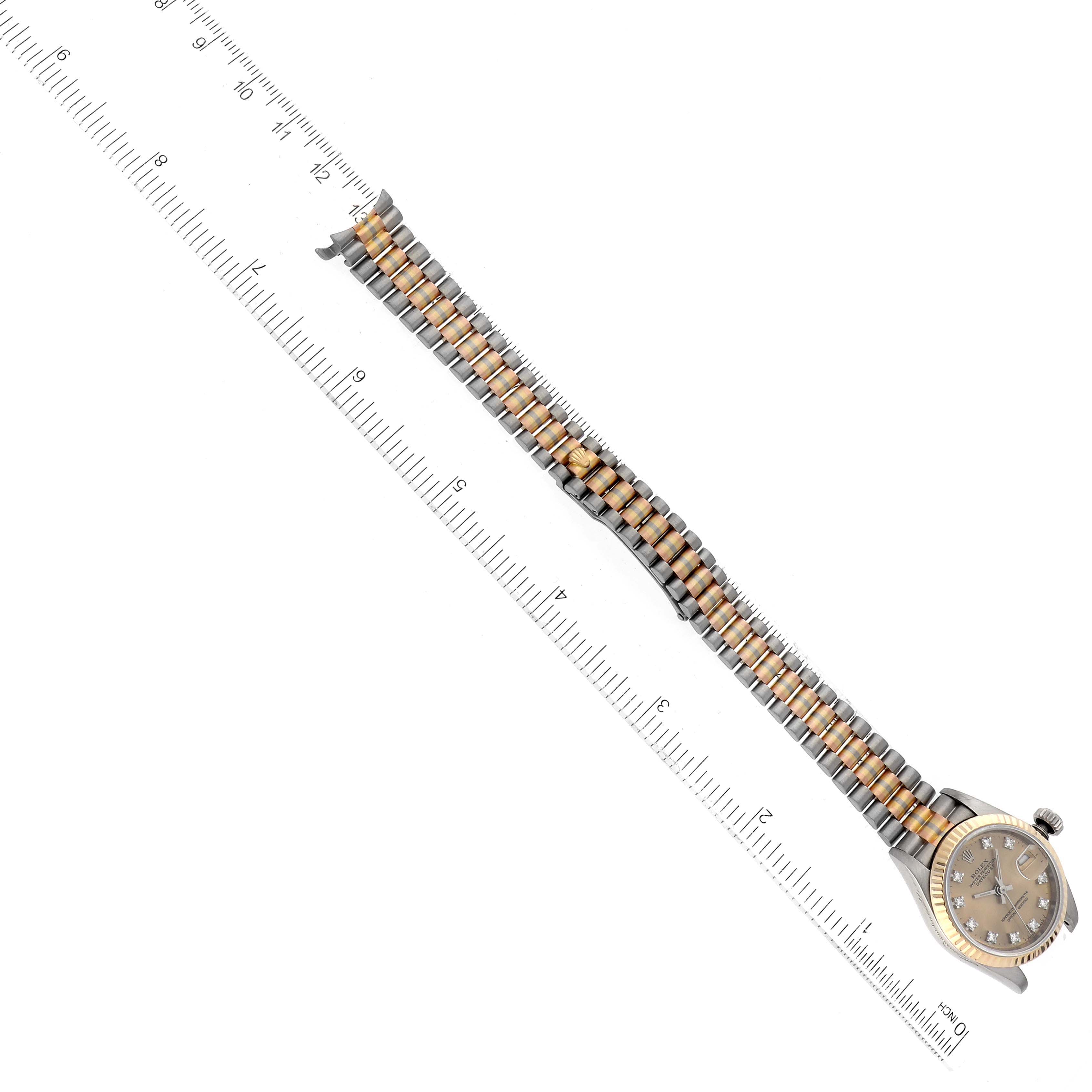 The image shows a Rolex President 69179 Women's White Gold Champagne Dial 69179 Women's White Gold Champagne Dial watch laid flat next to a ruler, highlighting the watch's bracelet and dial.