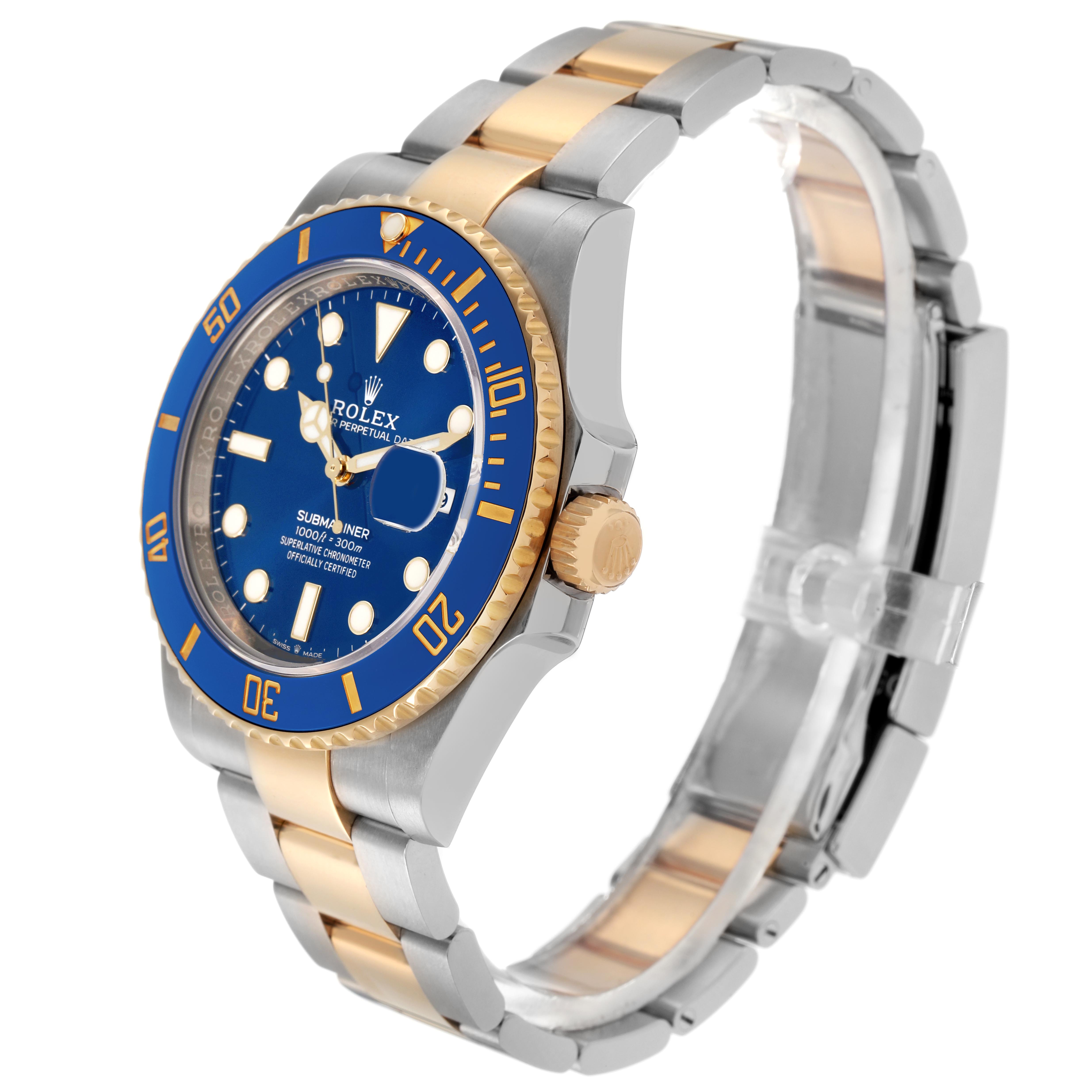 The Rolex Submariner 126613LB Men's Steel and Gold (two tone) Blue Dial 126613LB Men's Steel and Gold (two tone) Blue Dial watch is shown in a side angle, highlighting the blue dial, bezel, two-tone bracelet, and crown.