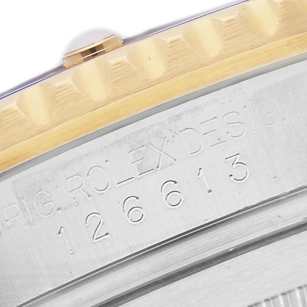 The image shows a close-up of the bezel and engraved numbers on a Rolex Submariner 126613LB Men's Steel and Gold (two tone) Blue Dial 126613LB Men's Steel and Gold (two tone) Blue Dial watch.