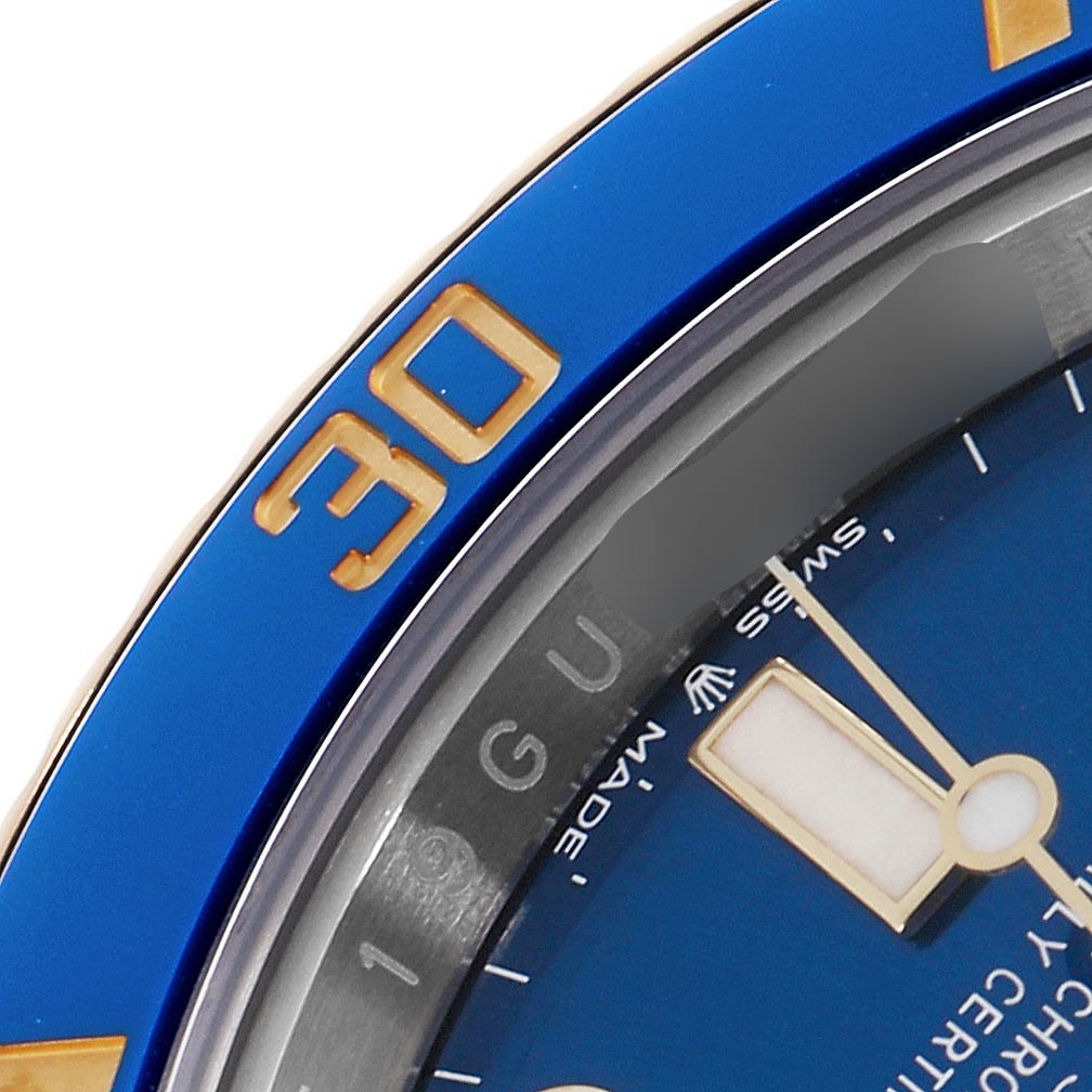 The image shows a close-up of the Rolex Submariner 126613LB Men's Steel and Gold (two tone) Blue Dial 126613LB Men's Steel and Gold (two tone) Blue Dial's blue bezel and part of the blue dial with a hand visible.
