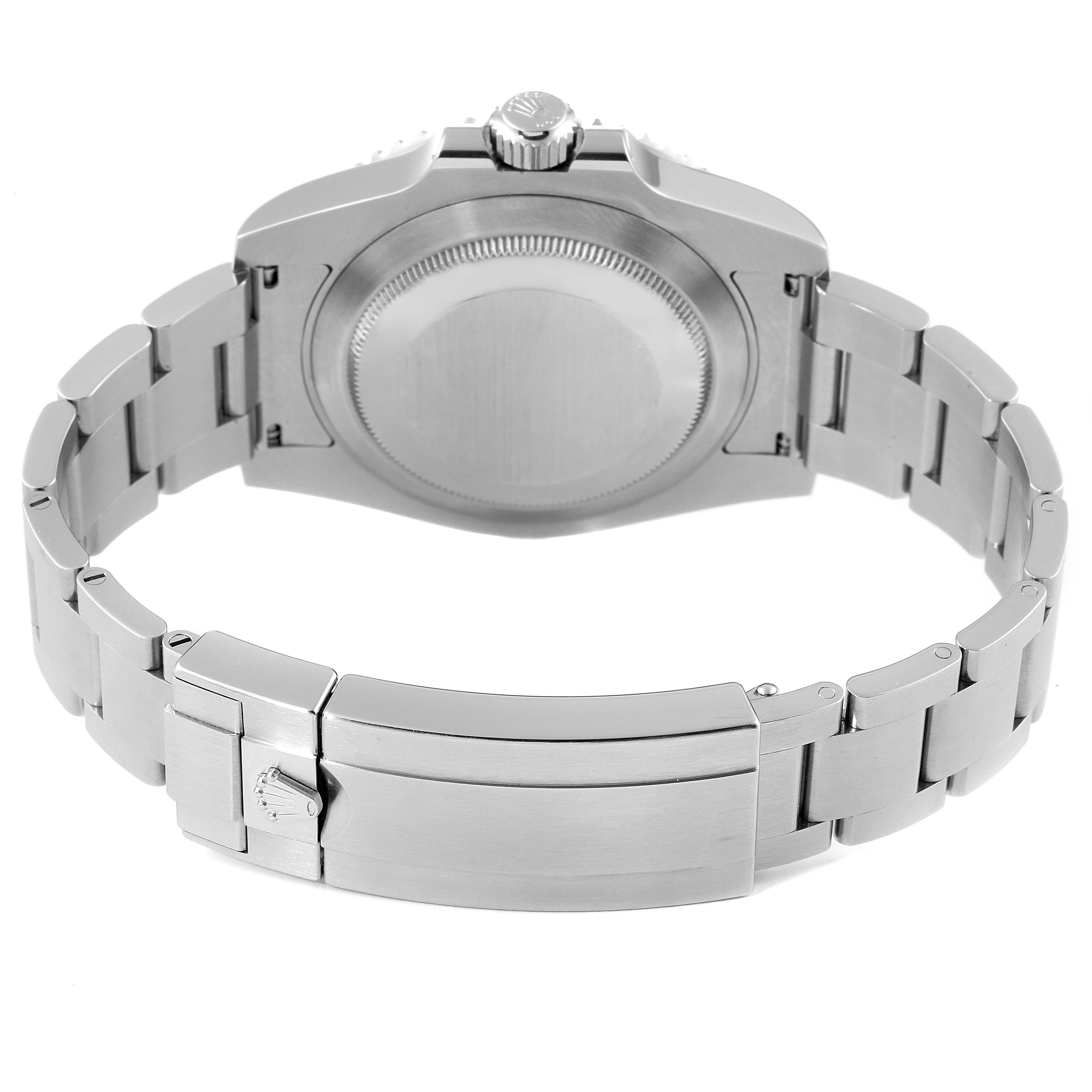 This image shows the backside of a Rolex Submariner 116610LV Men
s Stainless Steel Green Dial 116610LV Men
s Stainless Steel Green Dial watch, focusing on the case back, crown, and clasp of the metal bracelet.