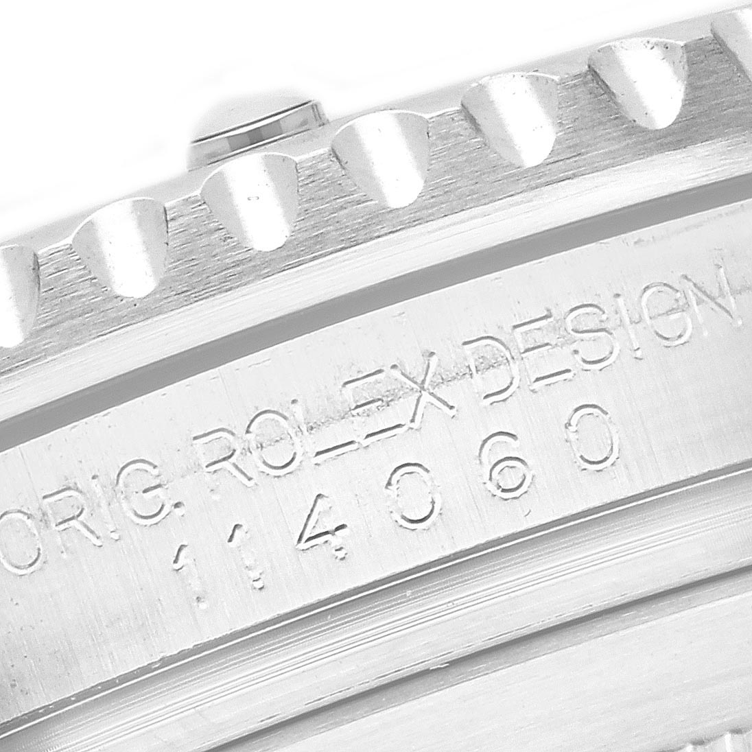 The image shows a close-up of the side engraving on a Rolex Submariner 114060 Men's Stainless Steel Black Dial 114060 Men's Stainless Steel Black Dial, highlighting the model number and design details.