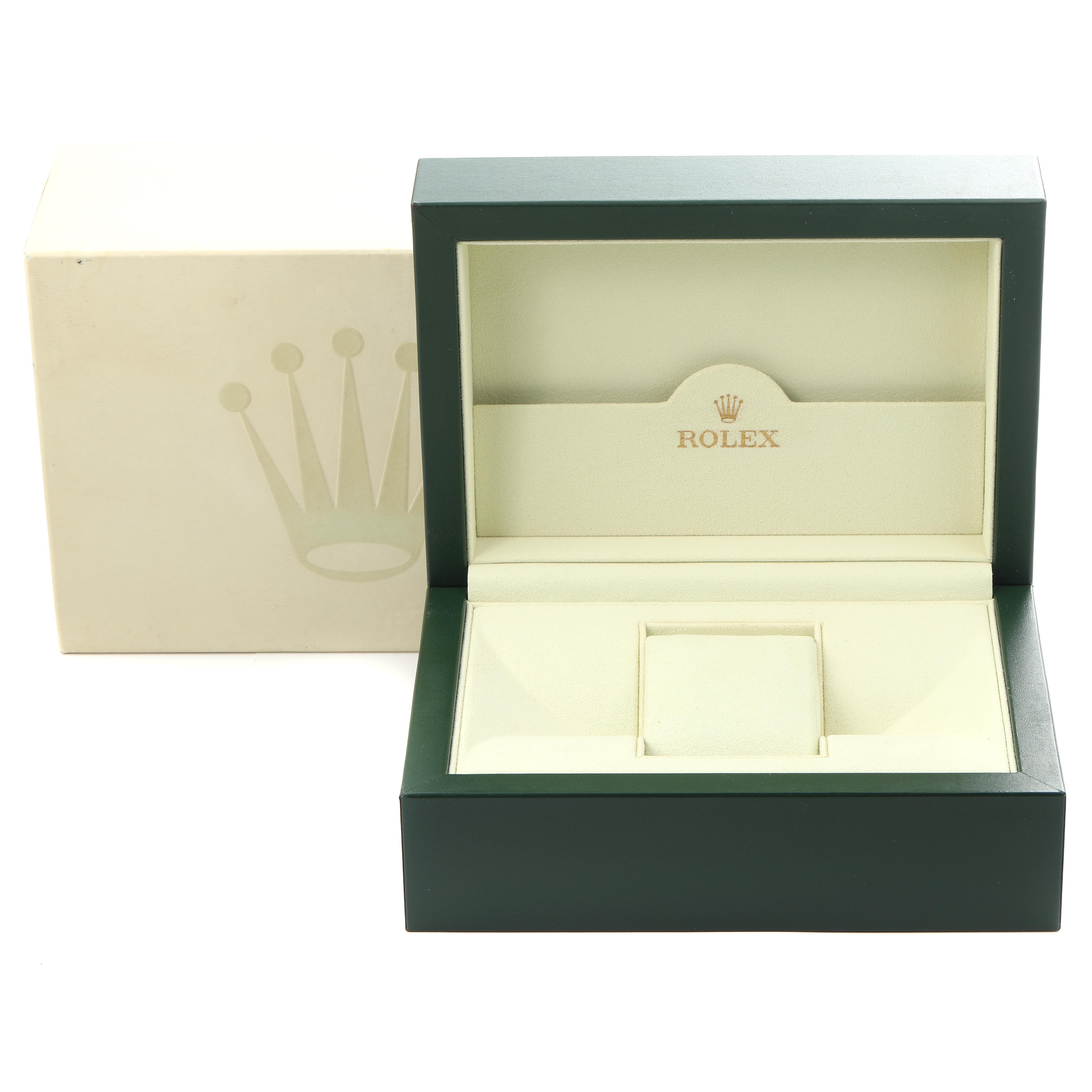 The image shows an open green Rolex box for a Submariner model, featuring the interior compartments and the brand logo.