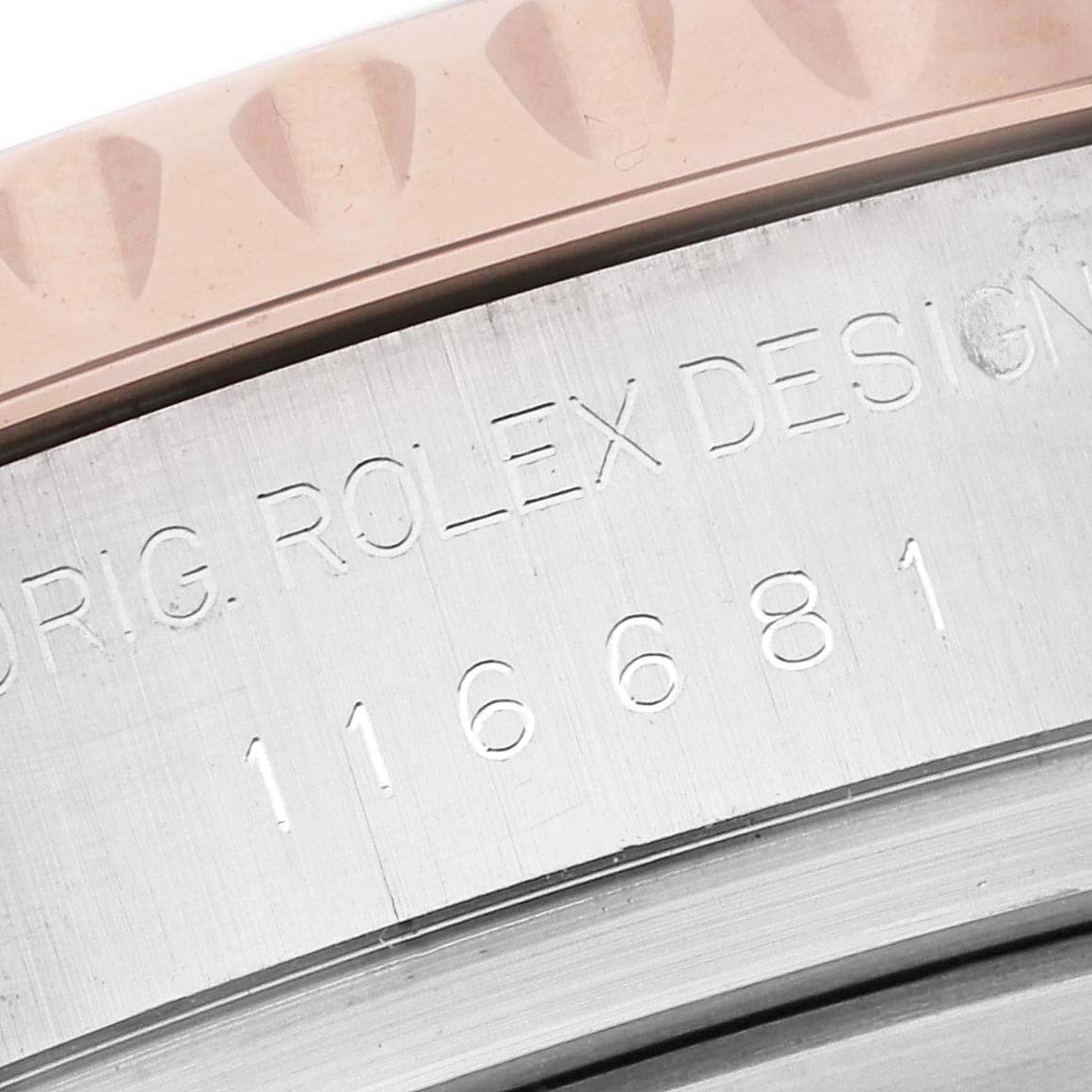 This close-up image shows the model number and part of the bezel of a Rolex Yacht-Master 116681 Men's Steel and Gold (two tone) White Dial 116681 Men's Steel and Gold (two tone) White Dial watch.