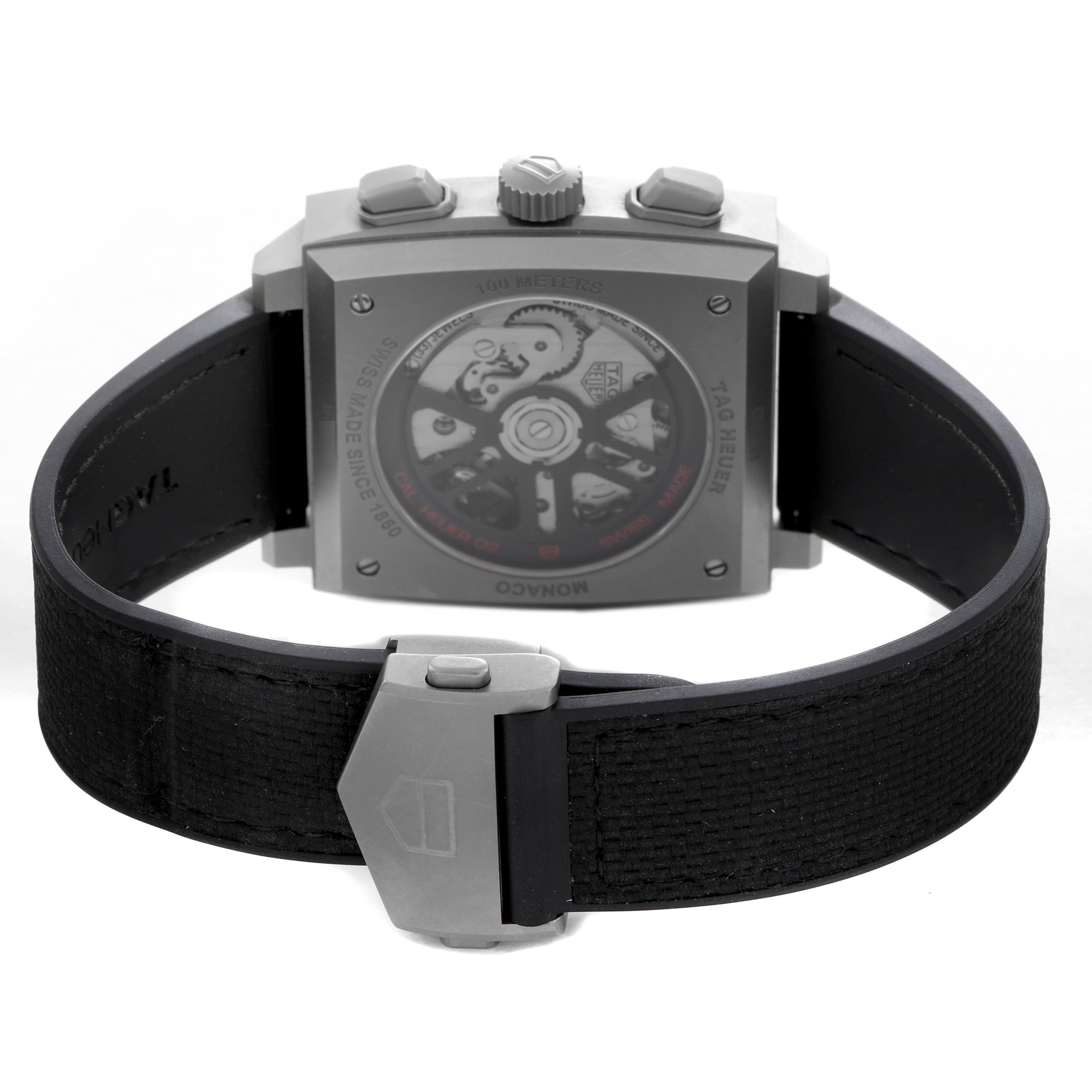The image shows the back view of the Tag Heuer Monaco CBL2183.FT6236 Men's Titanium Black Dial CBL2183.FT6236 Men's Titanium Black Dial watch, highlighting the movement and clasp details.