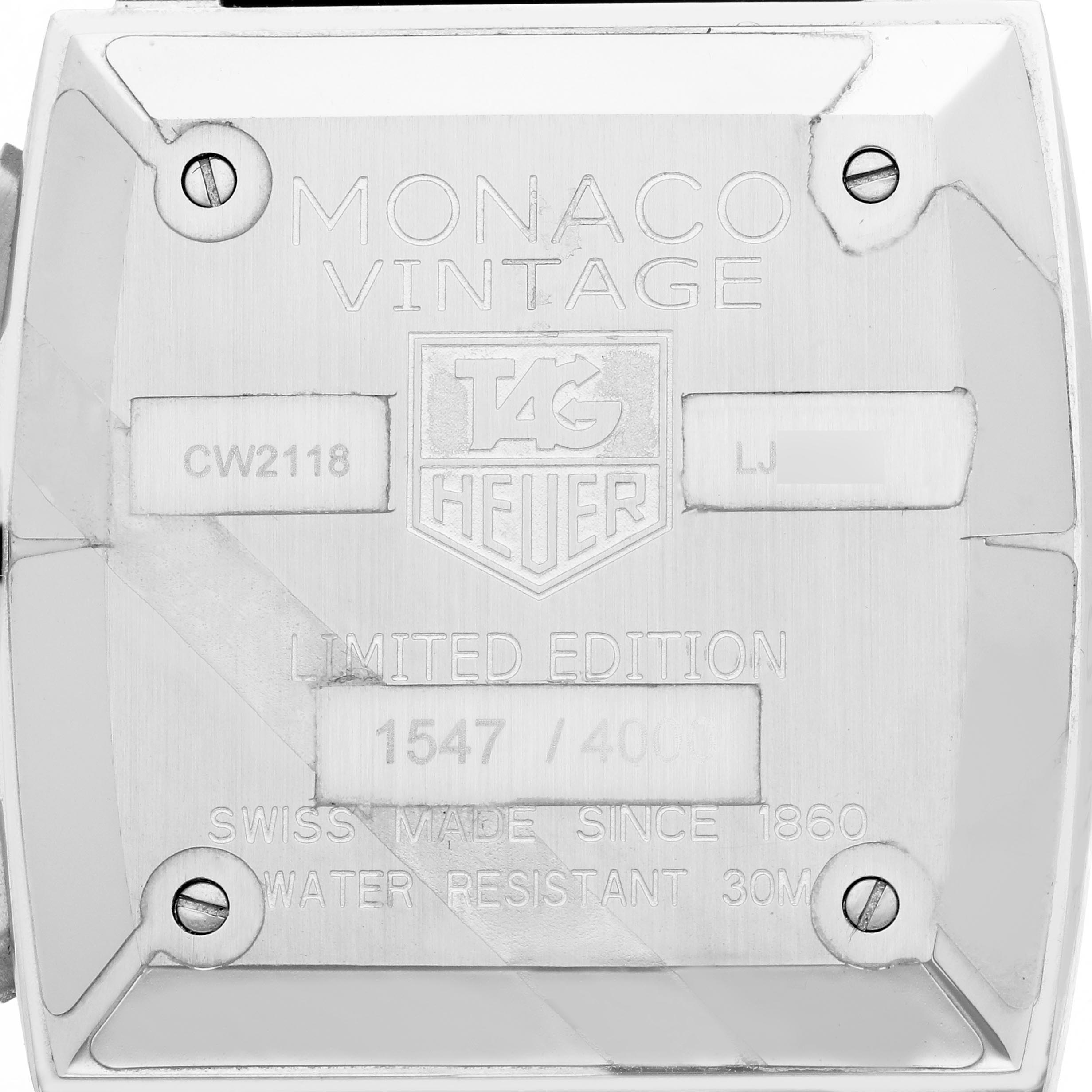 The image shows the case back of a Tag Heuer Monaco CW2118.FC6207 Men's Stainless Steel White Dial CW2118.FC6207 Men's Stainless Steel White Dial watch featuring engravings for model details and screws.