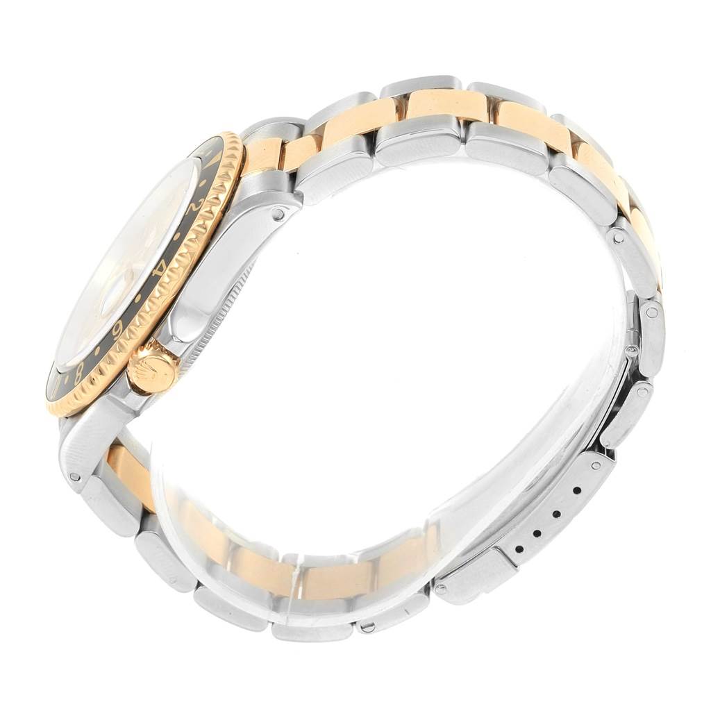 The image shows a side view of the Rolex 16713 Men
s Stainless Steel Champagne Dial 16713 Men
s Stainless Steel Champagne Dial GMT-Master II Yellow Gold Steel Diamond Ruby Serti Dial Watch, model 16713, focusing on the bracelet and case.