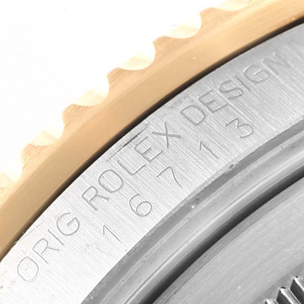 The image shows a close-up of the case edge on the Rolex 16713 Men
s Stainless Steel Champagne Dial 16713 Men
s Stainless Steel Champagne Dial GMT-Master II Yellow Gold Steel Diamond Ruby Serti Dial Watch 16713.