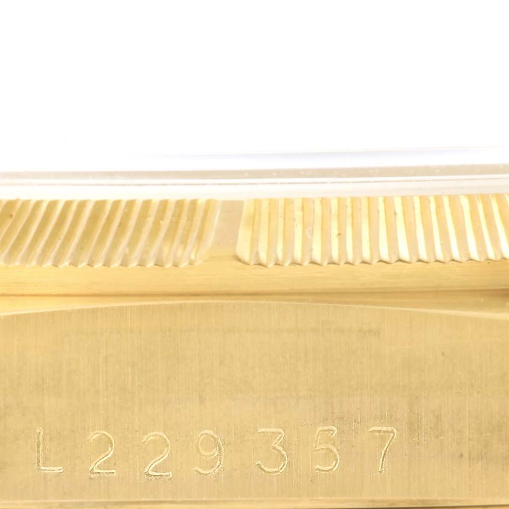 The image shows a close-up of the serial number engraving and part of the fluted bezel on the Rolex 18248 Men's Yellow Gold Black Dial 18248 Men's Yellow Gold Black Dial Day-Date President Yellow Gold Men's Watch 18248.