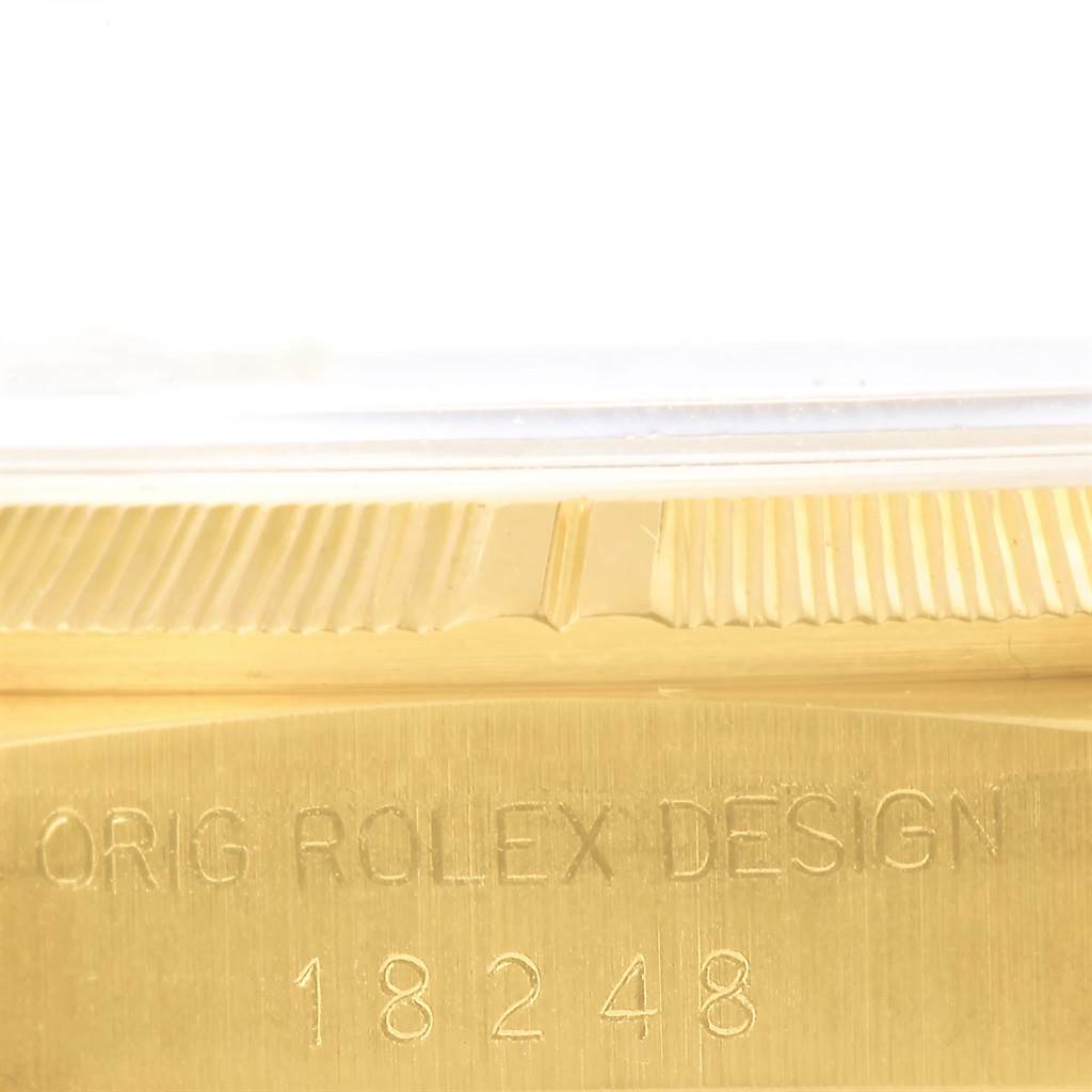 The image shows a close-up of the engraving and bezel of the Rolex 18248 Men's Yellow Gold Black Dial 18248 Men's Yellow Gold Black Dial Day-Date President Yellow Gold Black Diamond Dial Mens Watch 18248 model.