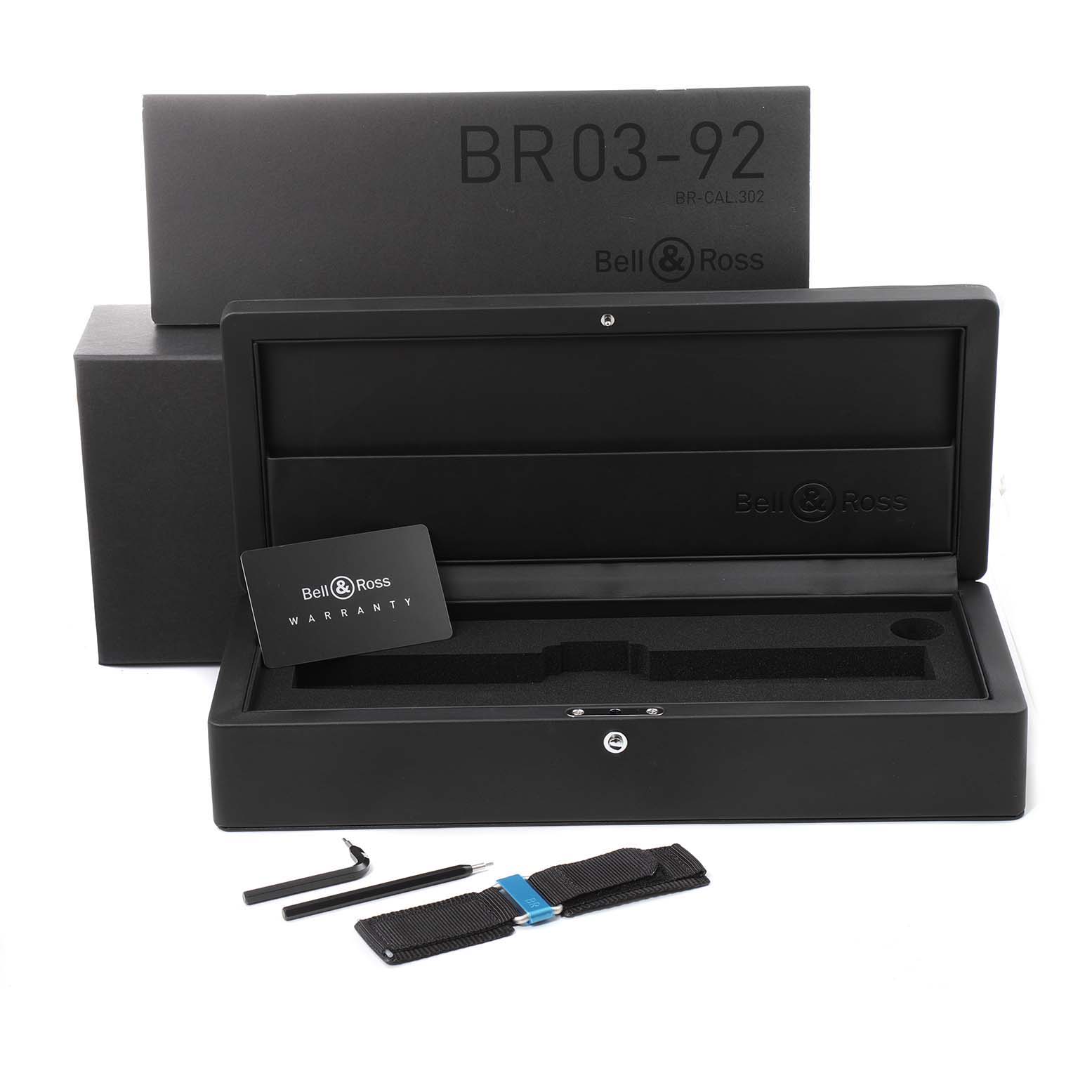 The image shows the packaging, warranty card, tools, and strap for the Bell & Ross BR0392 Aviation Blue Dial Automatic Steel Men’s Watch.