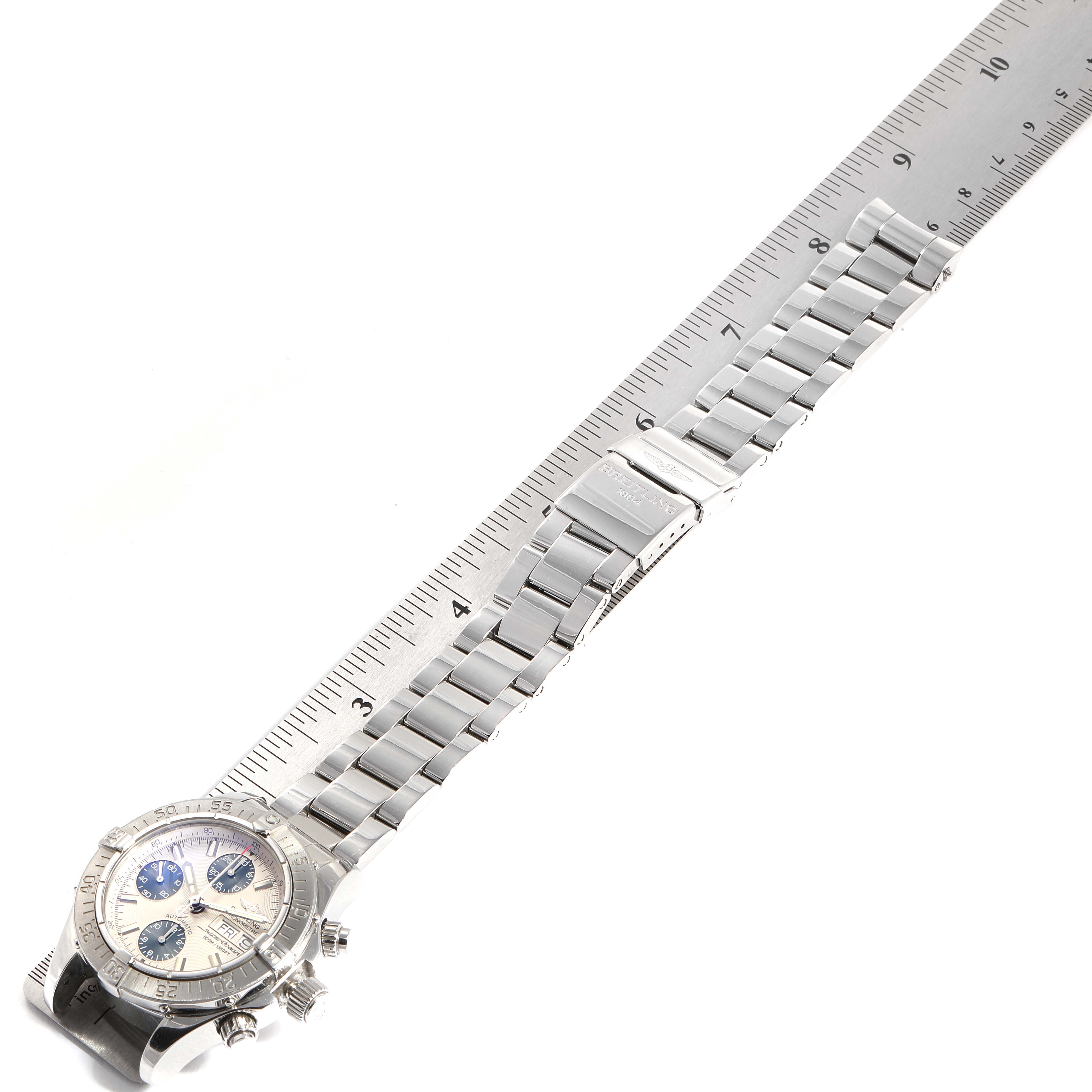 The image shows a Breitling Superocean A13340 Men's Stainless Steel Beige Dial A13340 Men's Stainless Steel Beige Dial watch from a top view, displaying its full metal bracelet, clasp, and face, with a ruler for scale.